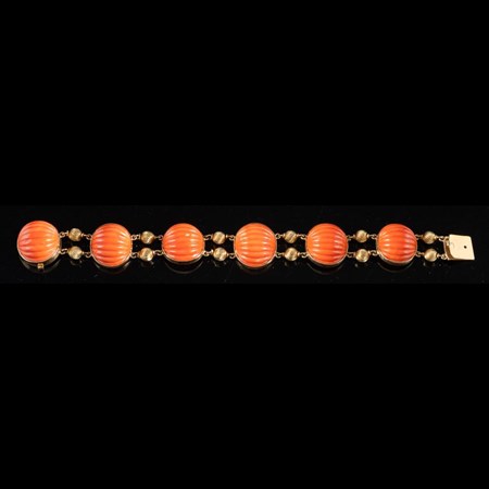A Mid 20Th Century Coral Bracelet, The Carved Oval Shaped Coral With Reeded Beads